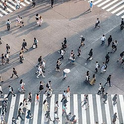 A group of people walking on a street.