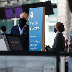 A man wearing a headset and a man wearing a mask.