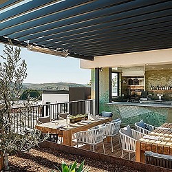 A deck with a pool and chairs.
