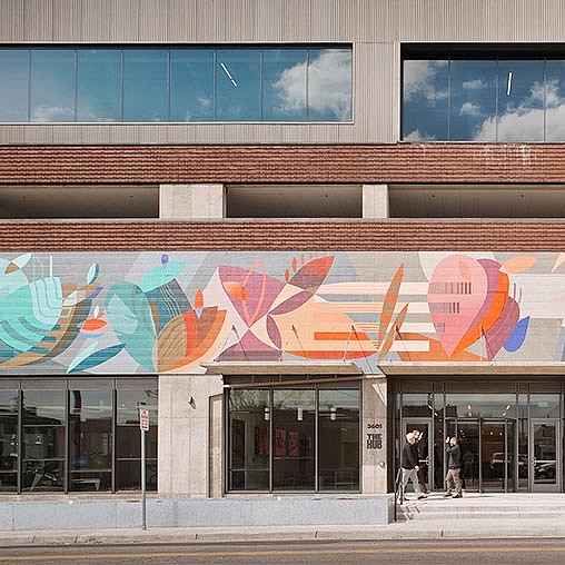 A building with a large mural on the side.