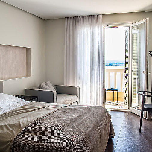 A bedroom with a large window.