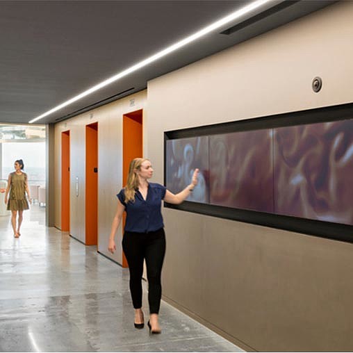 A woman pointing at a screen.