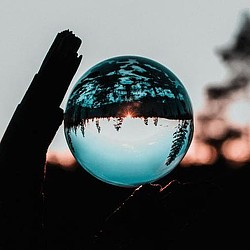 A hand holding a globe.