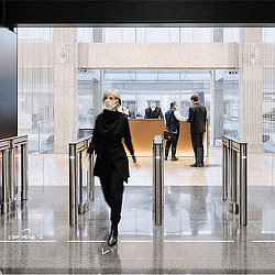 A man walking in a large office.