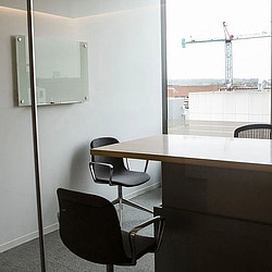 A table with chairs and a window.