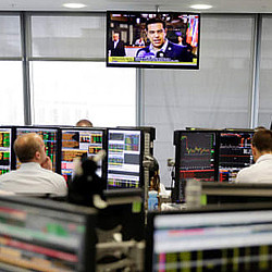 A group of people sitting at computers.