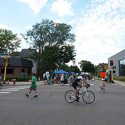 A group of people riding bikes on a street.
