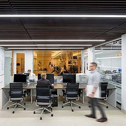 A person standing in front of a computer.