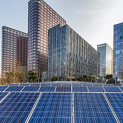 A swimming pool in front of a large building.