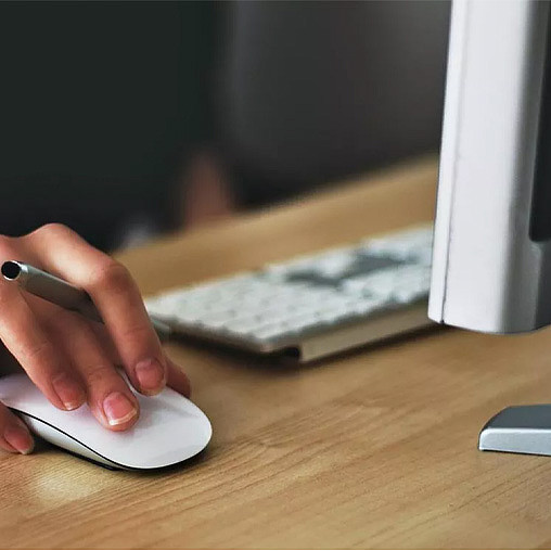 A hand on a mouse.