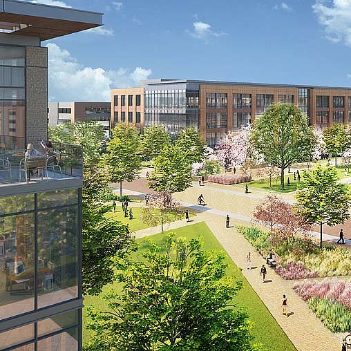A courtyard with trees and buildings in the background.