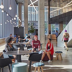 People sitting at tables in a building.