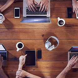 A group of hands holding cell phones.
