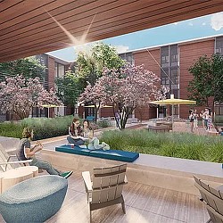 A group of people sitting on a bench in a courtyard.