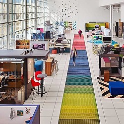 A few people walking in a building.