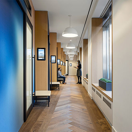 A person taking a picture of a hallway.