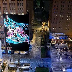 A city street with a large mural.