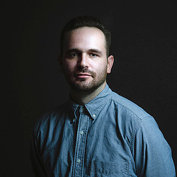 A man in a blue shirt.