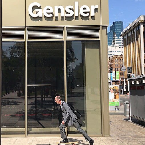 A person leaning against a glass door.
