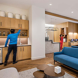 A man and woman in a kitchen.