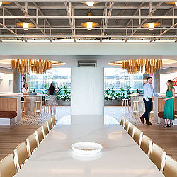 A large room with people and tables.