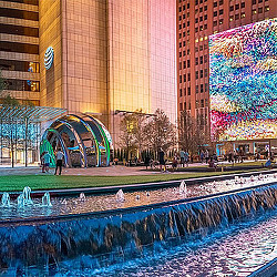 A large building with a pool in front of it.