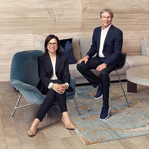 A man and woman sitting in chairs.