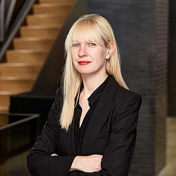 A woman in a black suit.