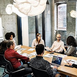 A group of people sitting around a table.