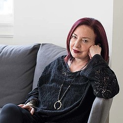 A woman sitting on a couch.