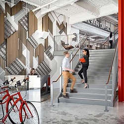 A man and woman walking down a flight of stairs.