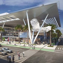A large building with a large glass dome and people walking around.