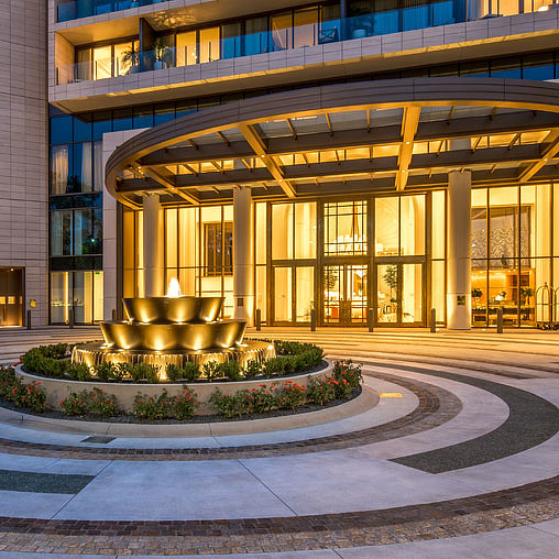 A building with a fountain in front.