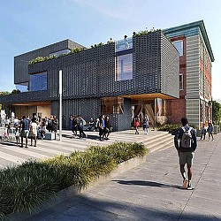 A group of people walking outside of a building.