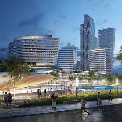 A group of people walking on a beach with tall buildings in the background.