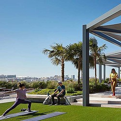 A man and a woman riding skateboards.
