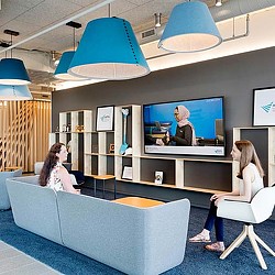 A person sitting in a chair in front of a television.