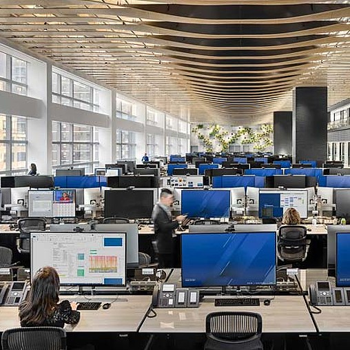 A person standing in front of a group of people sitting at computers.
