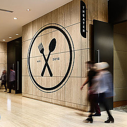 A person walking by a sign.