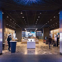 A person standing in a room with a large screen and a large display.