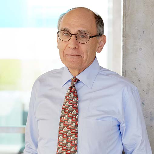 A man wearing glasses and a tie.