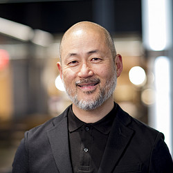 A bald man with a beard.