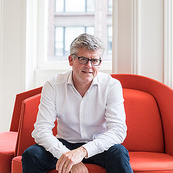 A person sitting on a red couch.