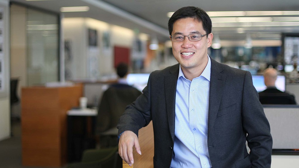 A man wearing a suit and glasses.