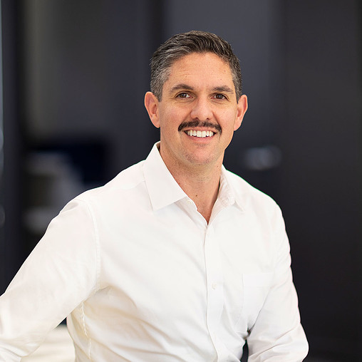 A man wearing a white shirt.