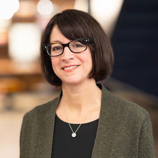 A woman wearing glasses.
