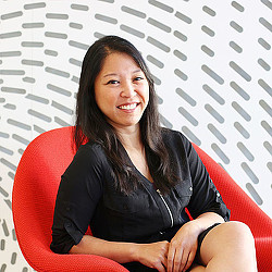 A woman sitting on a red chair.