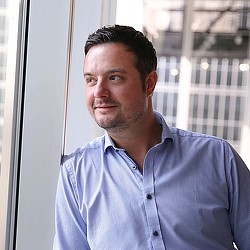 A man in a blue shirt.