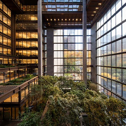 A building with plants growing in the front.