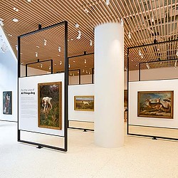 A museum with several framed paintings.